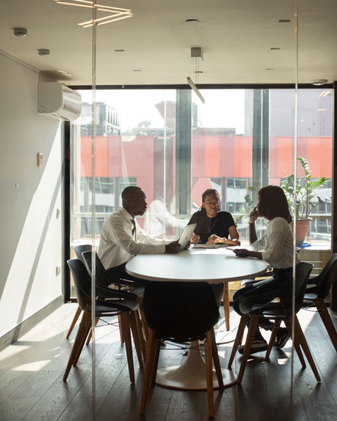 Business professionals in a modern office meeting room collaborating on projects.