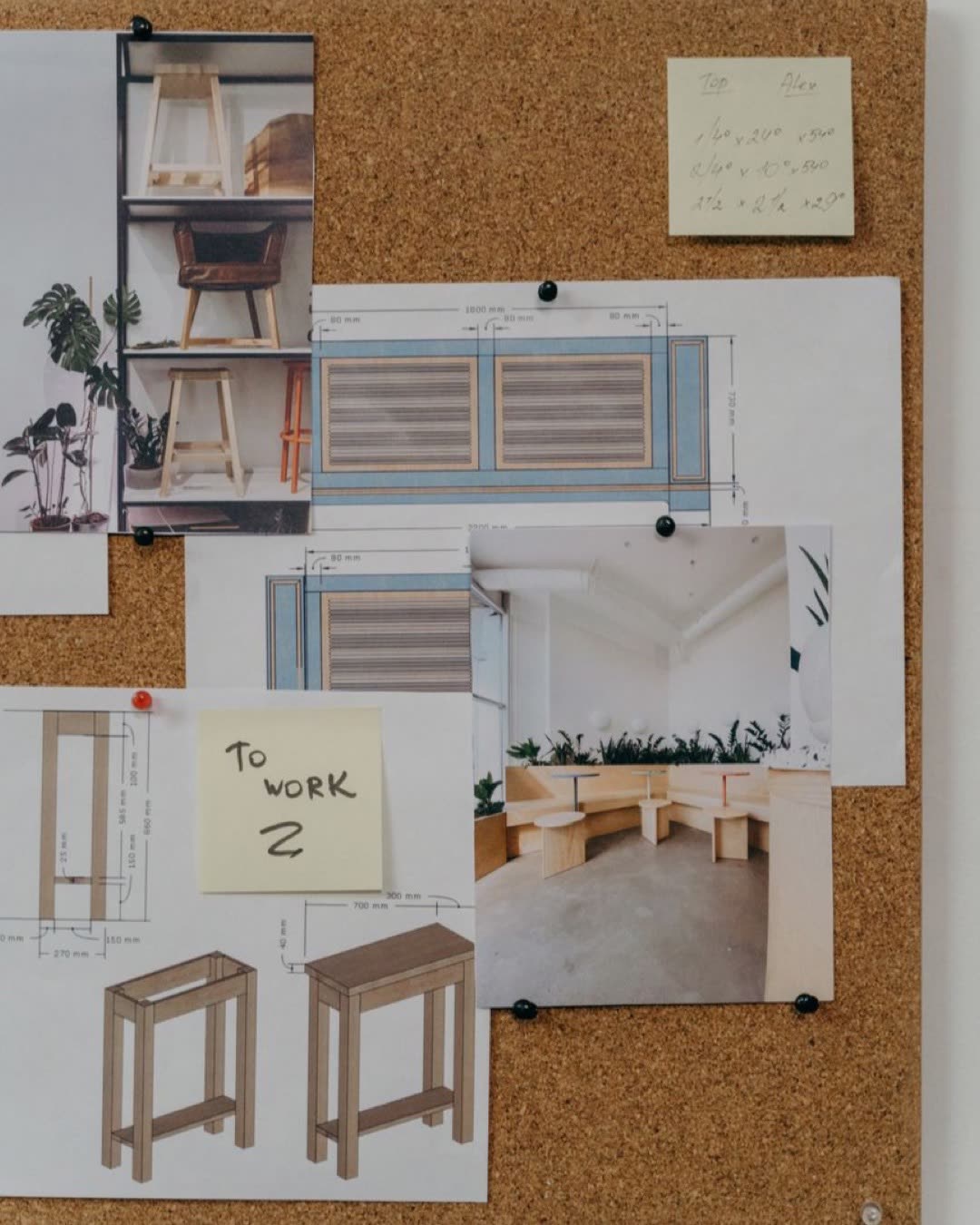 Cork board with interior design sketches and photos, showcasing creative workspace ideas.