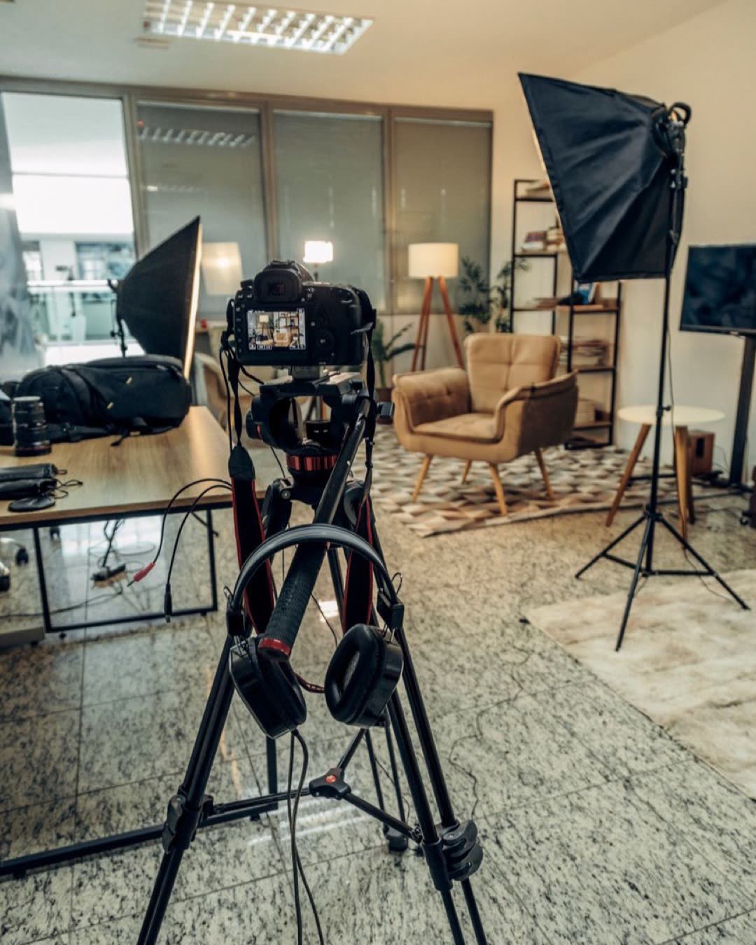 An indoor professional photography studio setup with camera and lighting equipment ready for a photoshoot.