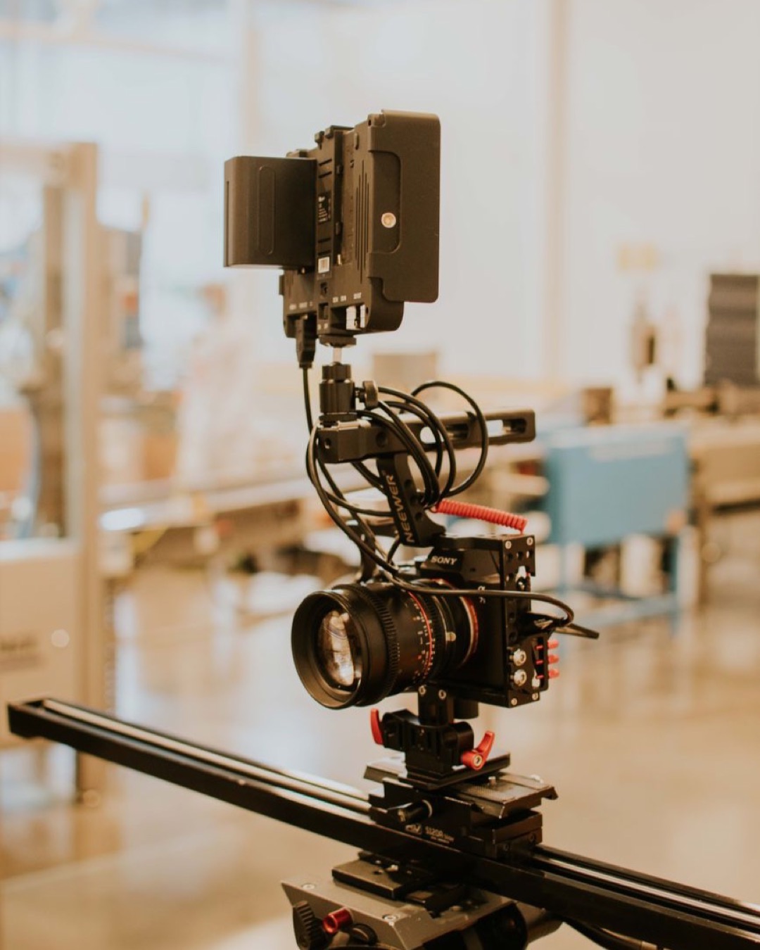 Close-up of a professional camera rig setup on a tripod in a modern studio setting.