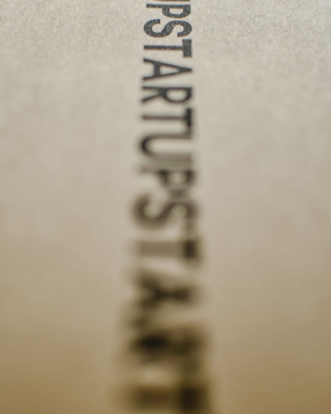 Blurred focus on the word 'Startup' on a textured paper surface.