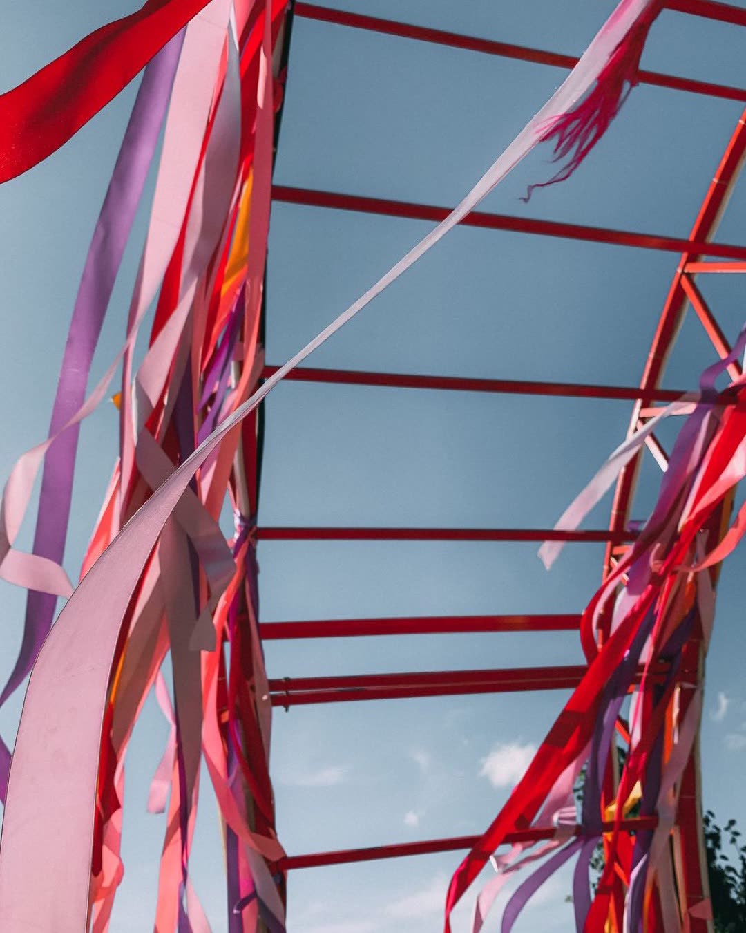 Vibrant ribbons stream in the breeze against a clear blue sky, creating a festive atmosphere.