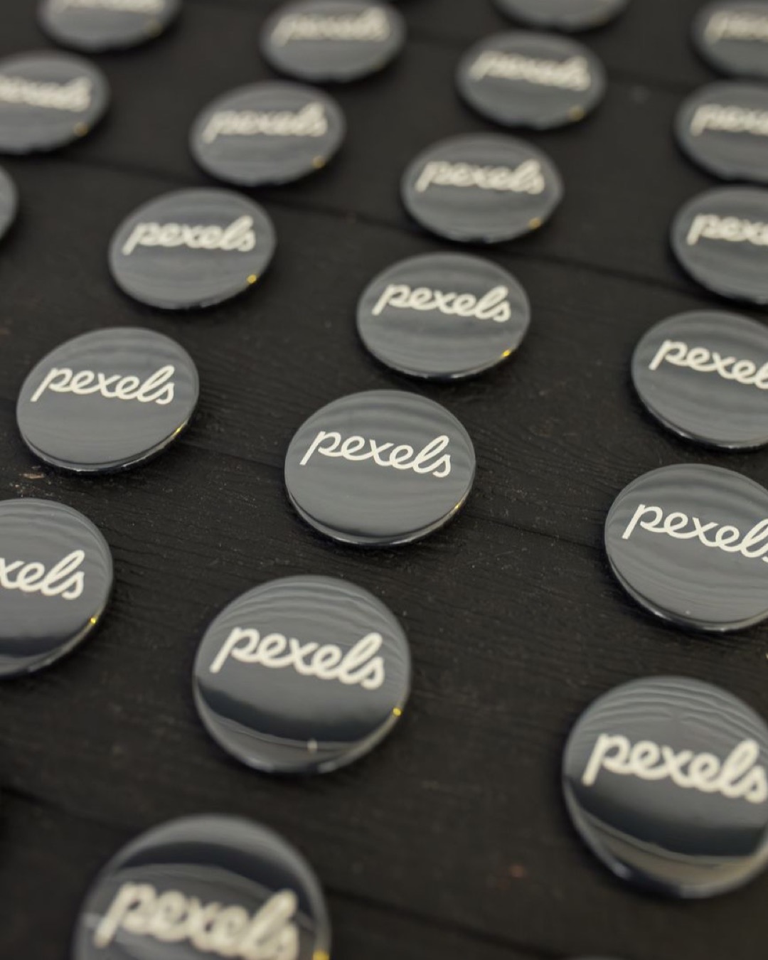 Rows of Pexels badges neatly arranged on a dark surface.