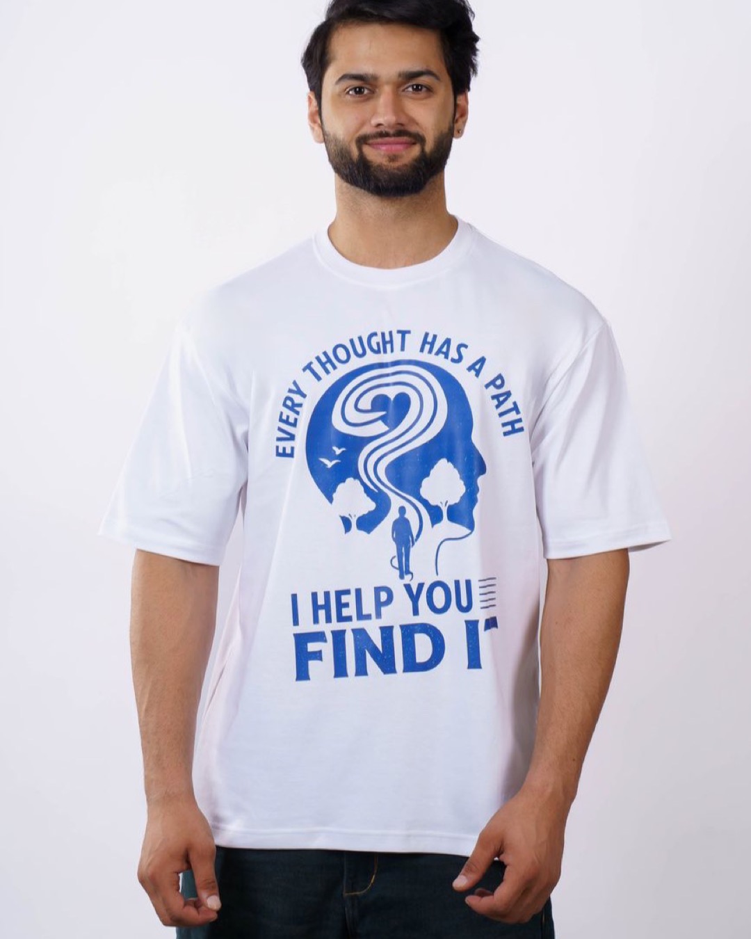 A man wearing a white t-shirt with a motivational print, standing against a plain background.
