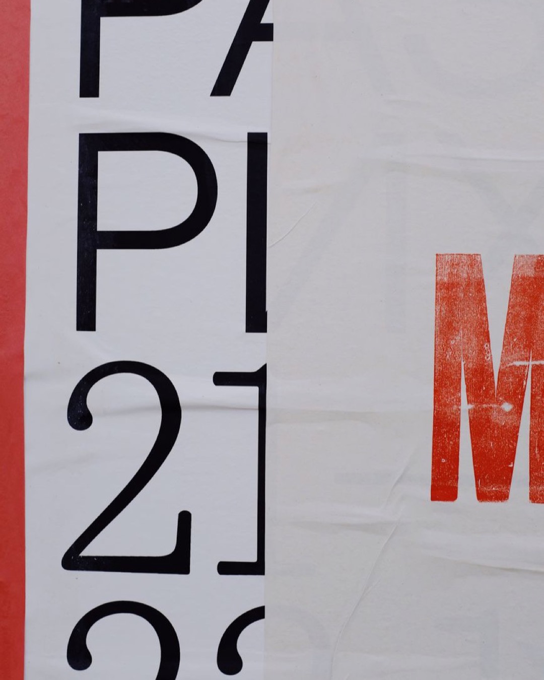 Letters and numbers printed on white banner placed on wall of modern building on street in city
