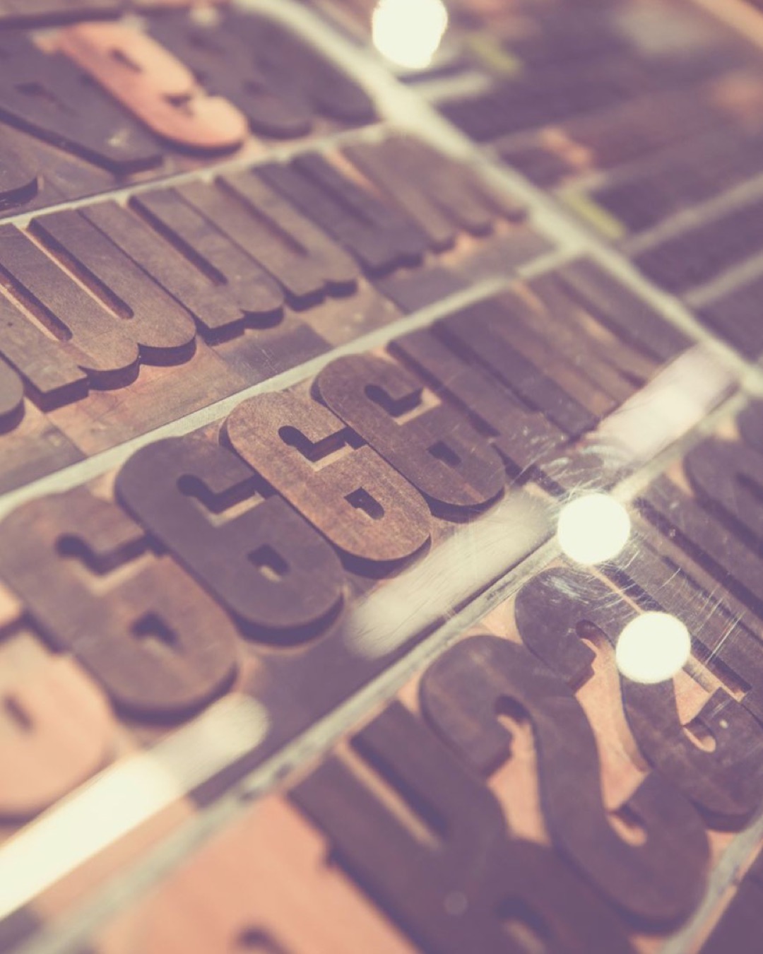 Close-up of vintage wooden letterpress type blocks on display.
