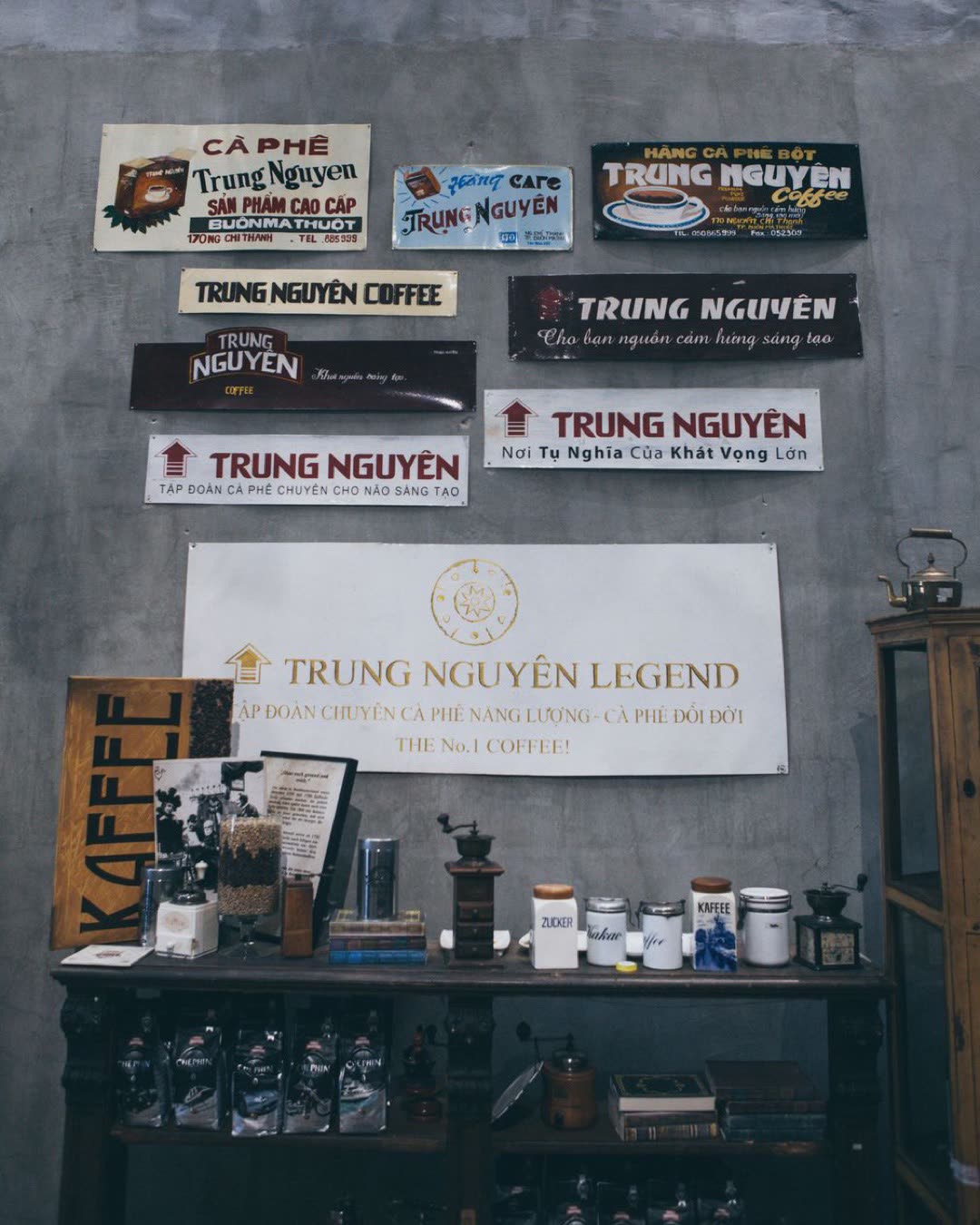 Interior view of a Trung Nguyen coffee shop, showcasing various signage and coffee-related items on display.