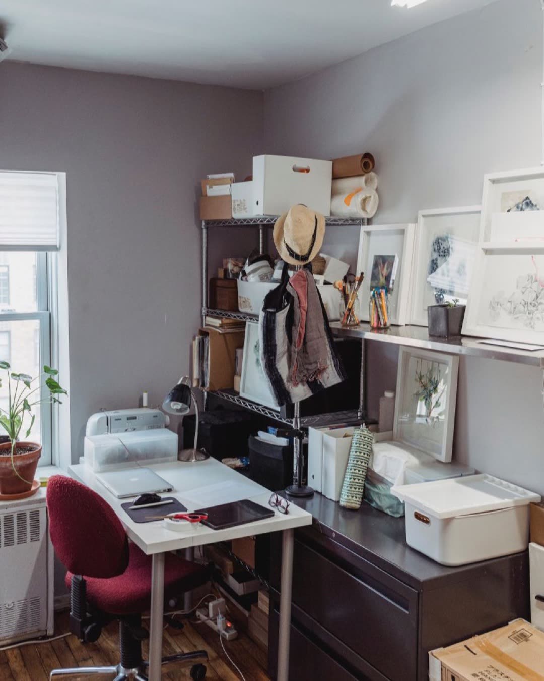 Compact home office with natural light, showcasing organized desk and creative storage solutions.