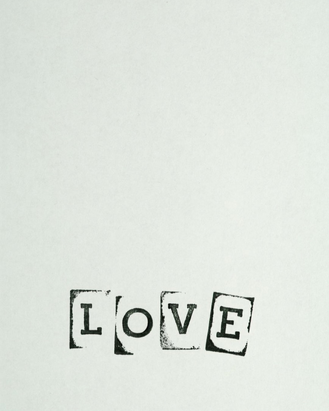 A simple black and white minimalist design featuring the word love, ideal for romantic messages.