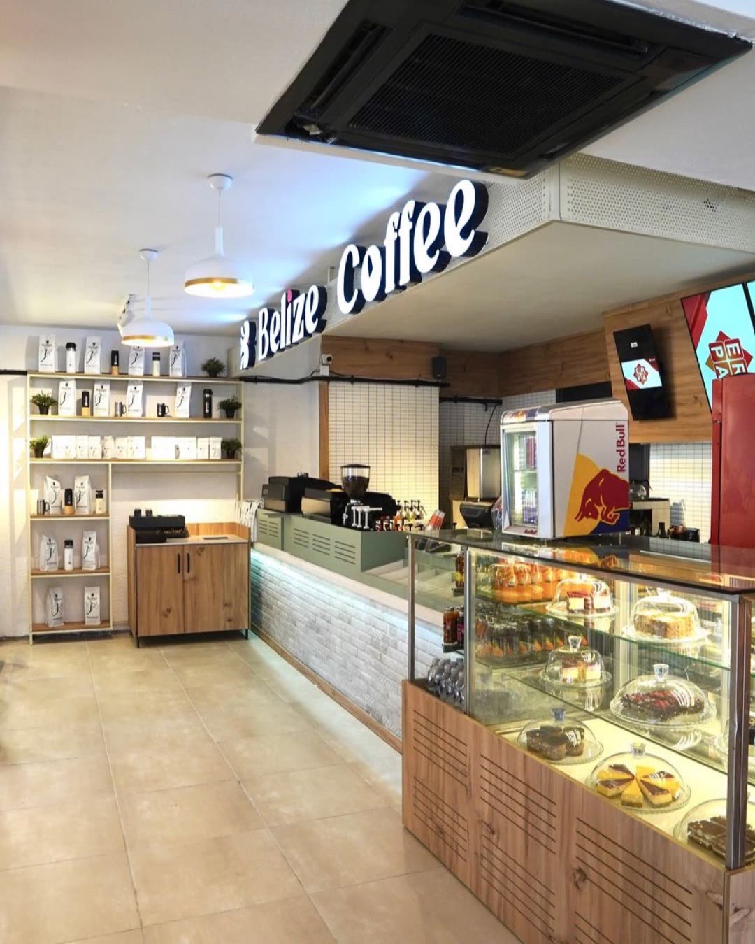 Bright interior of a cozy coffee shop with pastries and coffee display.