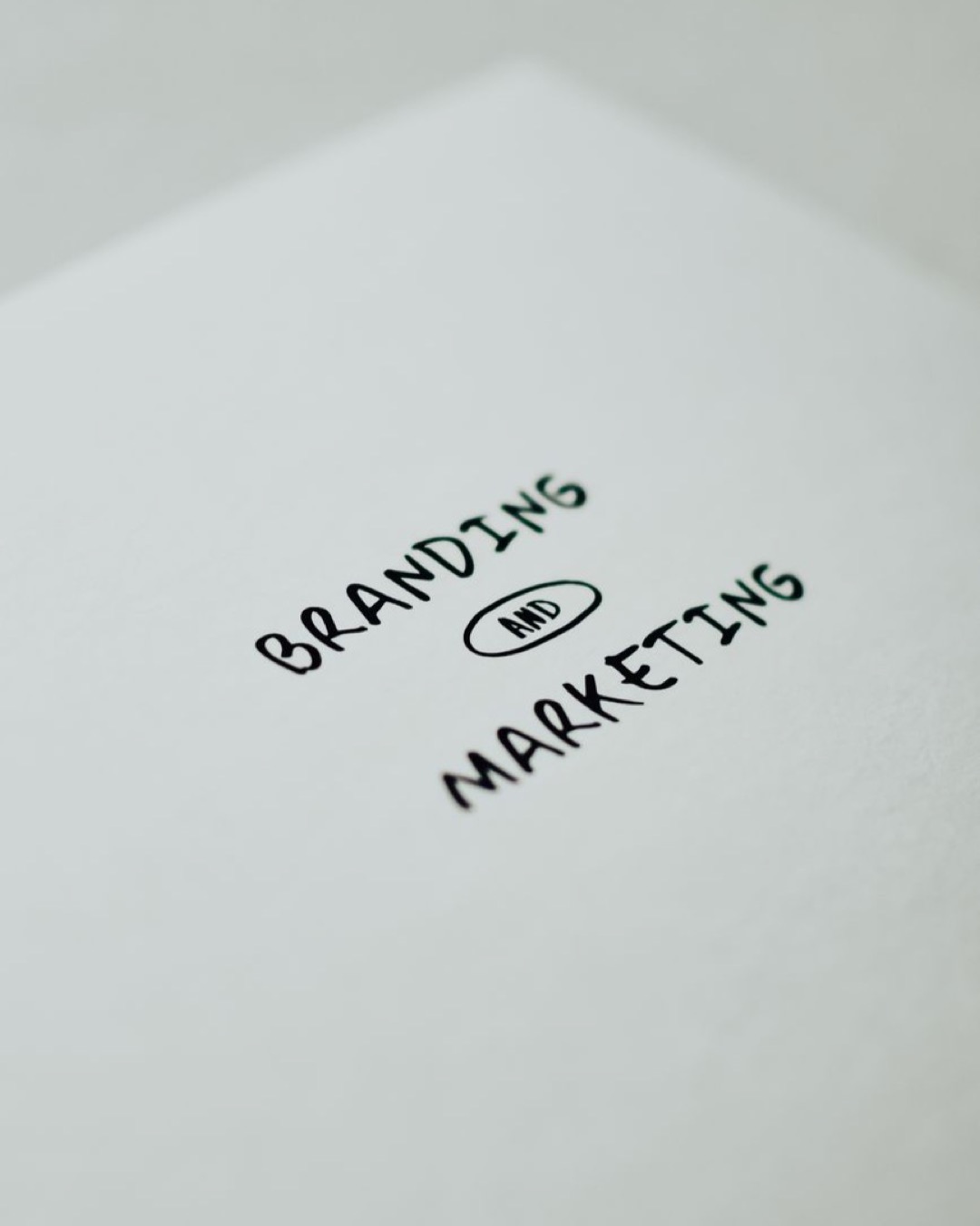 Minimalistic design showcasing 'branding and marketing' text for business strategy visuals.