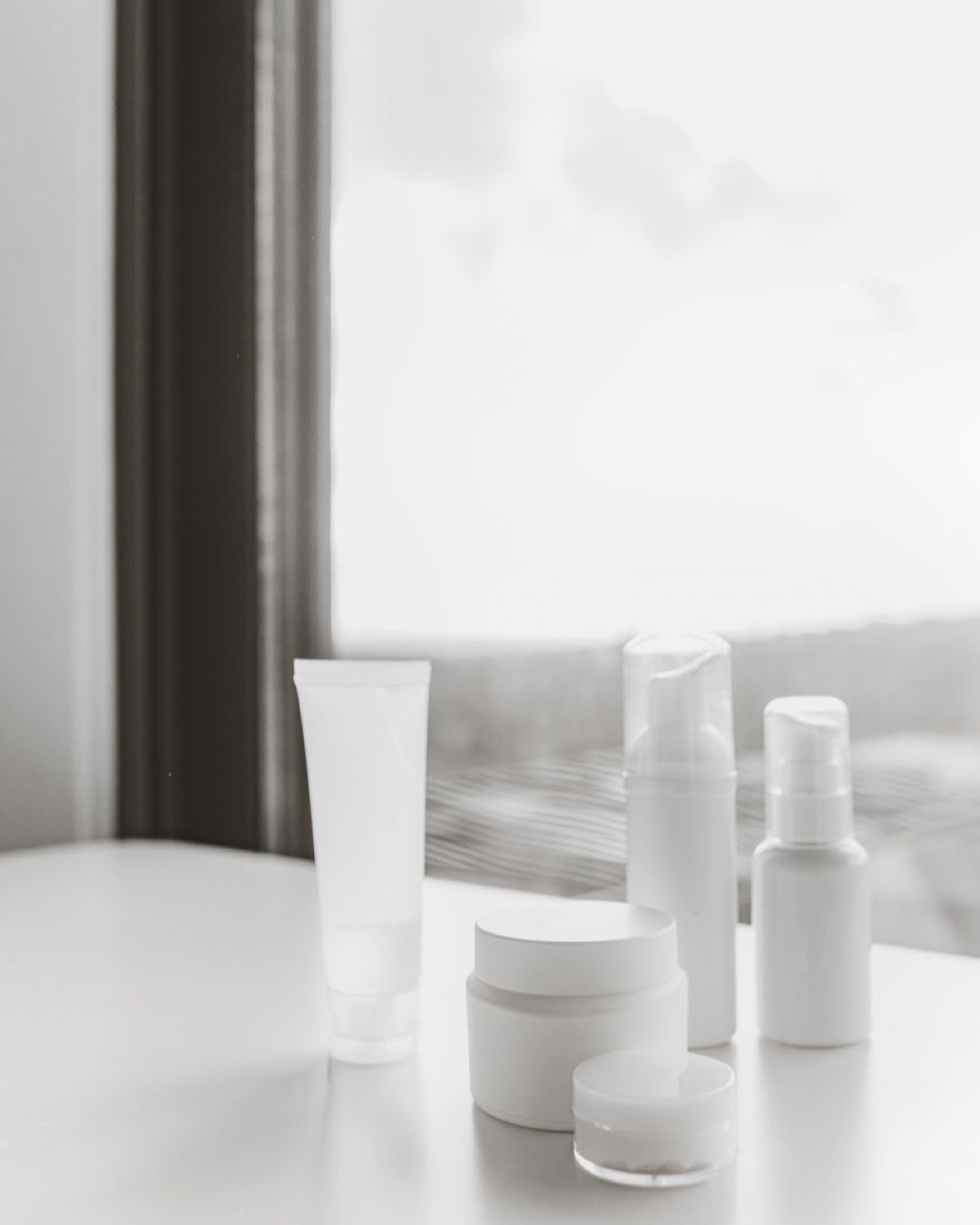 Elegant display of skincare products in a minimalist and natural setting.