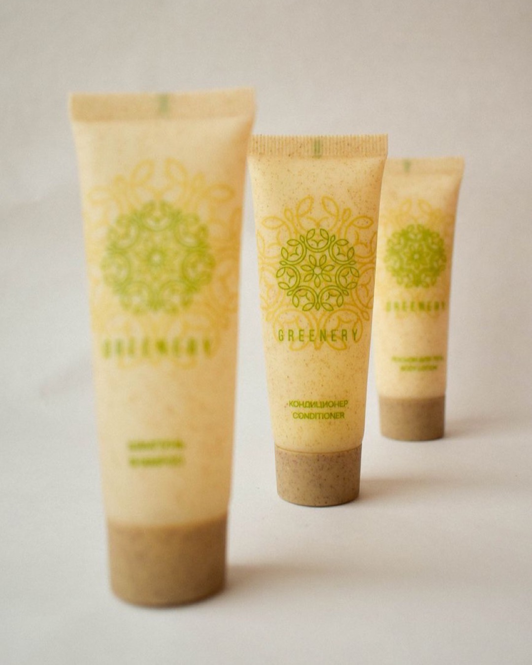 Eco-friendly skincare tubes arranged artfully on a beige backdrop.