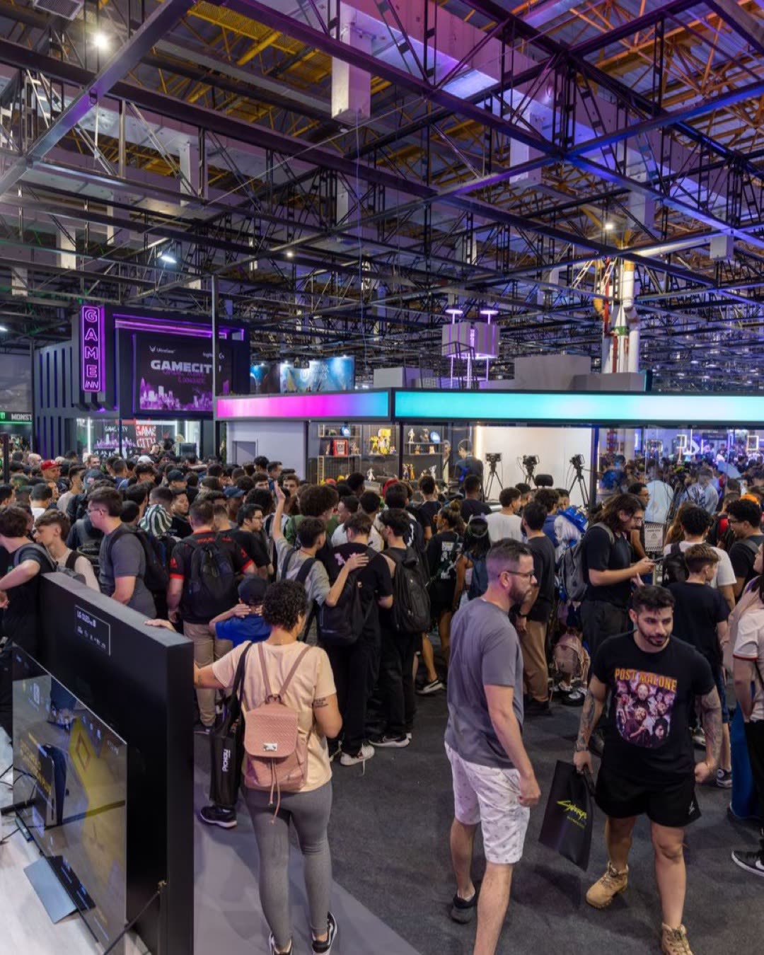 A bustling crowd at a technology convention, showcasing vibrant energy and diverse attendees.