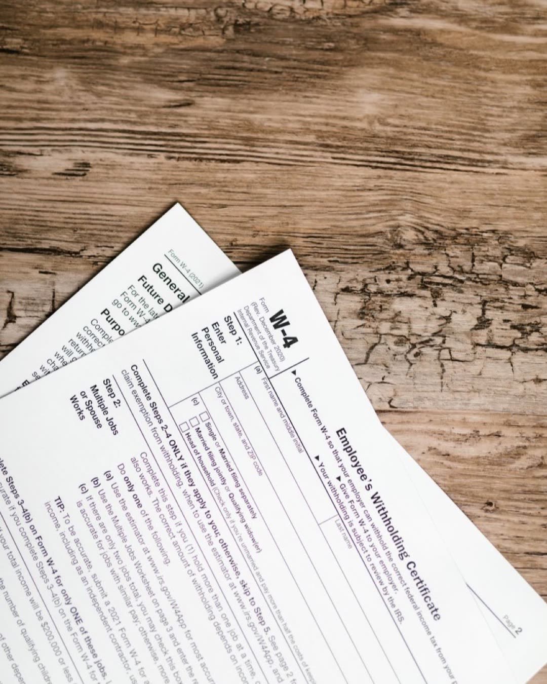 Detailed shot of tax forms on a wooden surface, ideal for concept themes like finance and documentation.