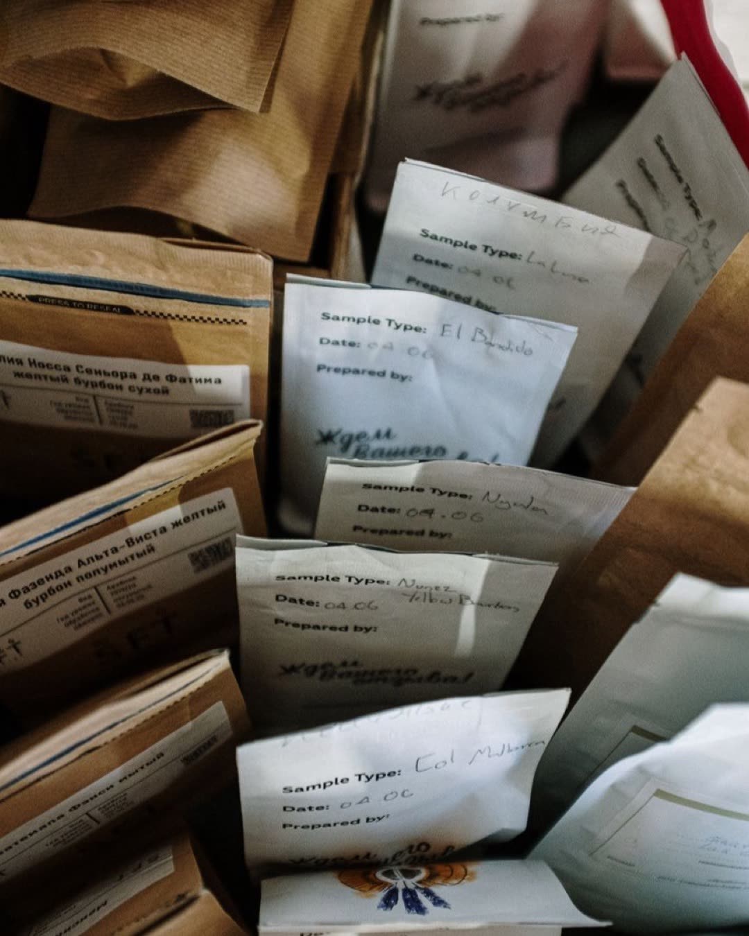 Overhead view of various coffee sample bags with labels, ideal for coffee enthusiasts.