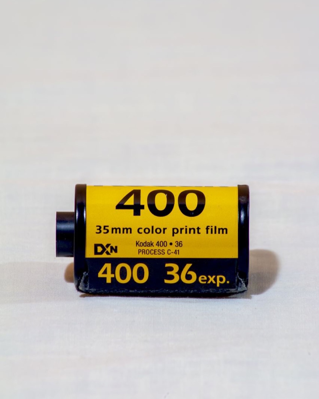 Detailed image of a 35mm color print film roll with yellow Kodak label.