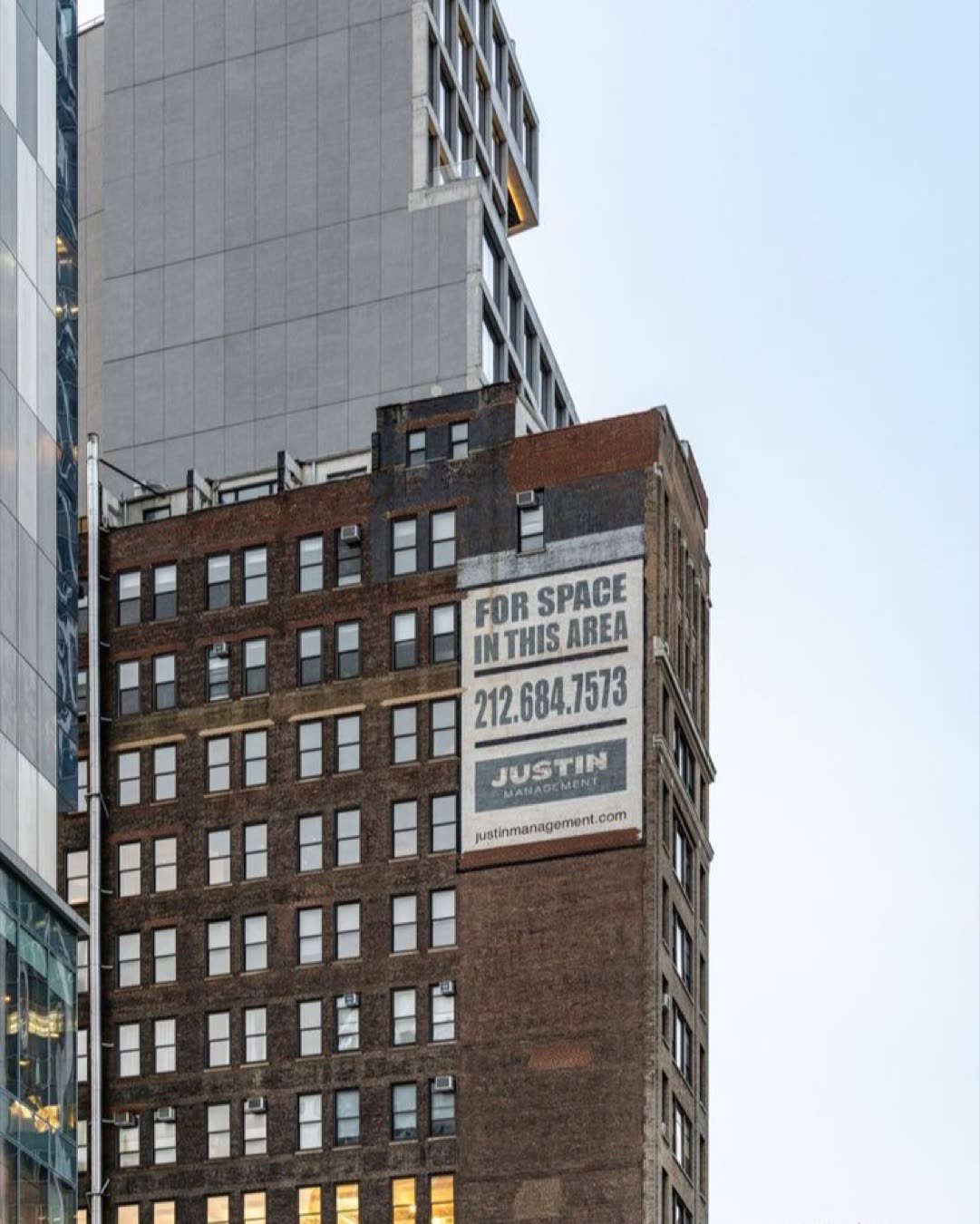 High-rise building with commercial real estate signage in NYC's urban landscape.