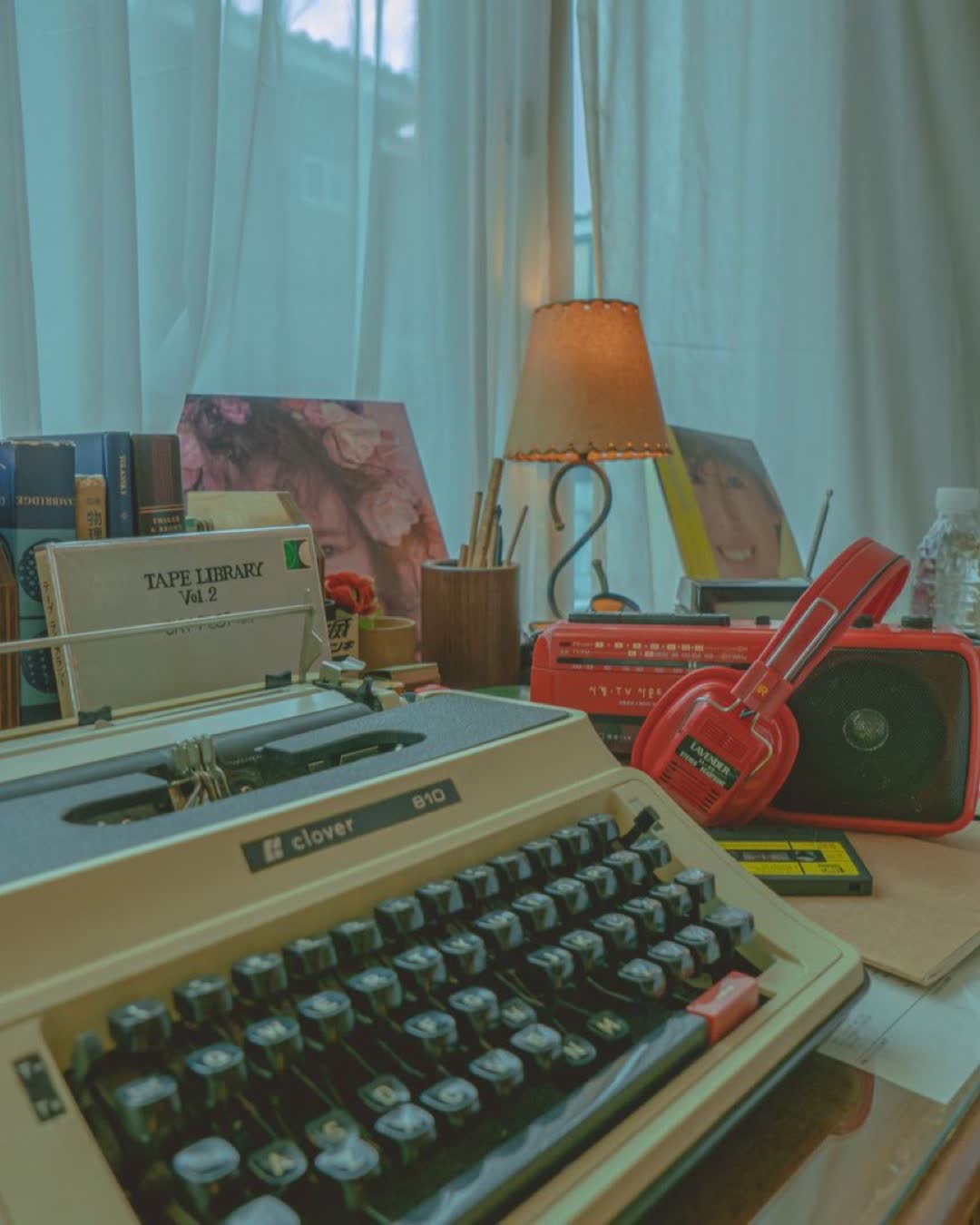 Explore a vintage-themed desk with a typewriter, retro gadgets, and warm lighting.