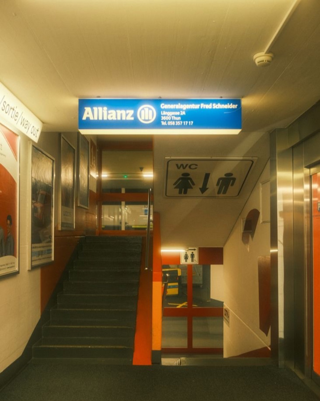 Interior view showing Allianz signage and staircase in office building.