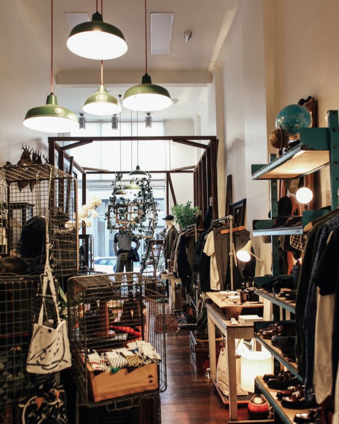 Stylish vintage boutique showcasing fashion items and decor with warm lighting and unique displays.