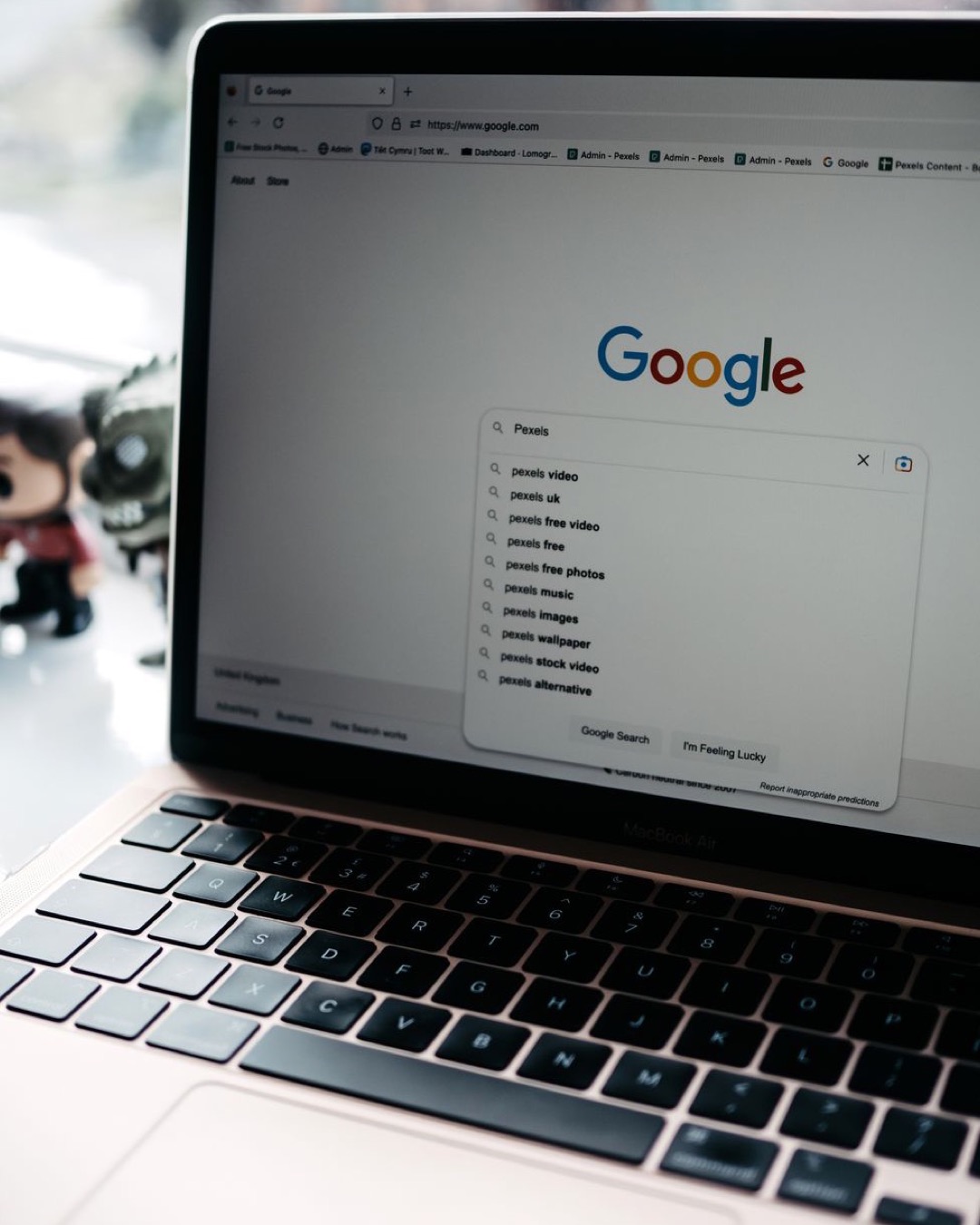 A close-up shot of a laptop displaying a Google search page with related searches visible.